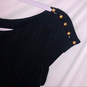 black dress with gold studs and tie around back